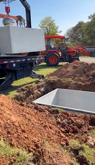 Crane and tractor at storm shelter installation in Lubbock TX