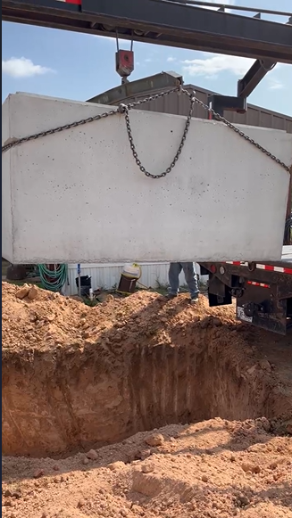 Shelter suspended by chains over excavation in Roaring Springs TX