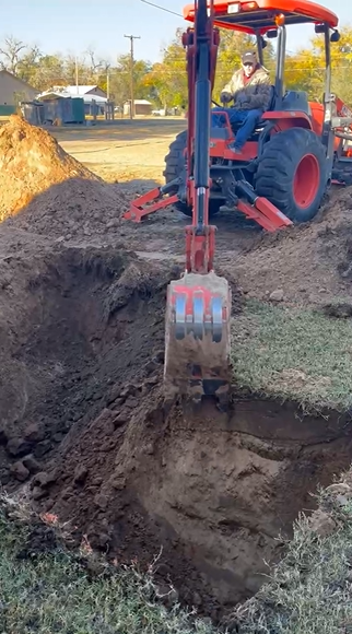 Kubota digging hole for storm shelter in Roaring Springs TX