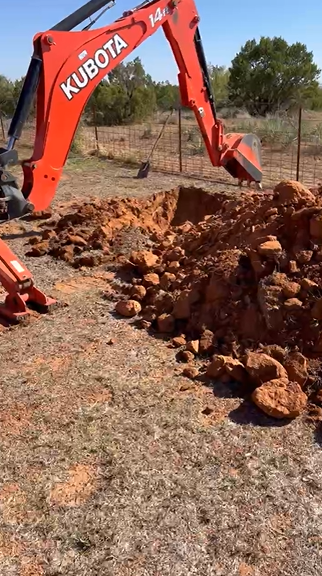 Rocky soil excavation during storm shelter install in Spur TX