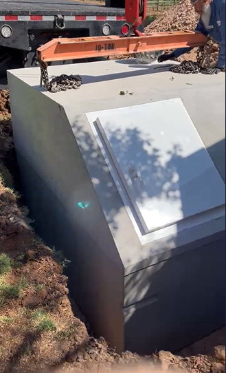 Concrete storm shelter seated in ground in Spur TX